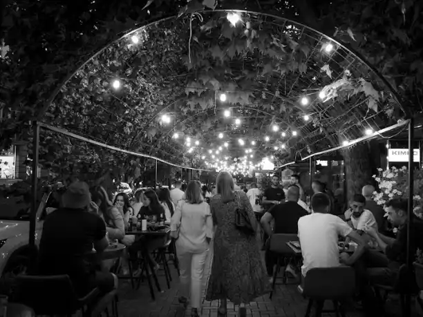 A street in Prishtina at night with string lights