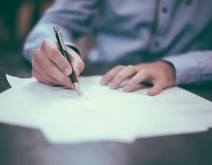 A hand writing on paper